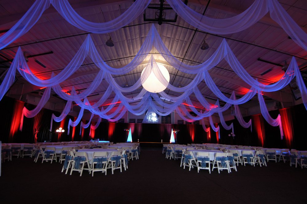Custom event draping in white chiffon by W Drapings for a wedding reception in a sporting facility in Central Florida. Photo by Concept Photography.