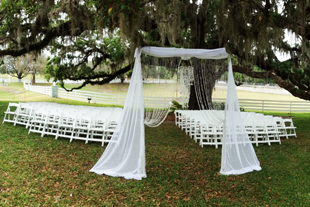 Custom chiffon detail with decorative strings of crystal beads for an outdoor ceremony at Highland Manor in Apopka, FL. Photo and drapes by W Drapings.
