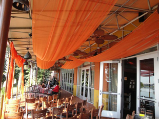 Custom ceiling treatments in festive orange chiffon for a wedding reception at Samba Room in Orlando, FL. Photo and drapes by W Drapings.